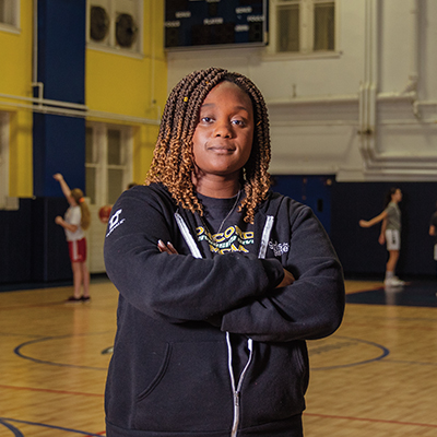 Alecia alongside kids playing basketball